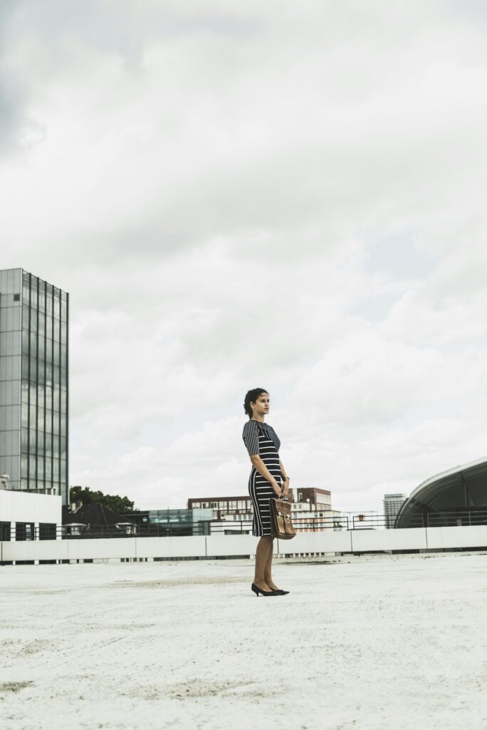 Young businesswoman standing on parking deck